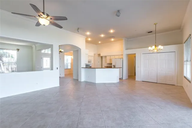 a view of a house with a ceiling fan and kitchen view