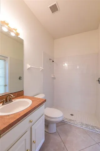 a spacious bathroom with a granite countertop sink mirror and a bathtub