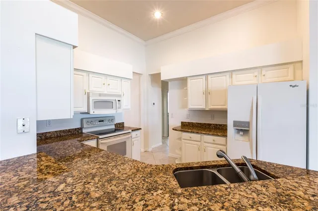 a kitchen that has a sink and a stove in it