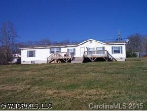 207 Keeter Road Waynesville, NC 28786 - Photo 2 of 8 a front view of a house with a garden and porch