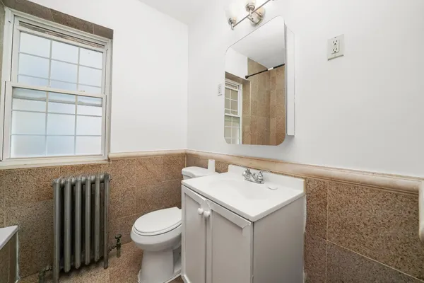 a bathroom with a sink a toilet and mirror
