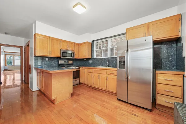 a kitchen with granite countertop stainless steel appliances and wooden cabinets