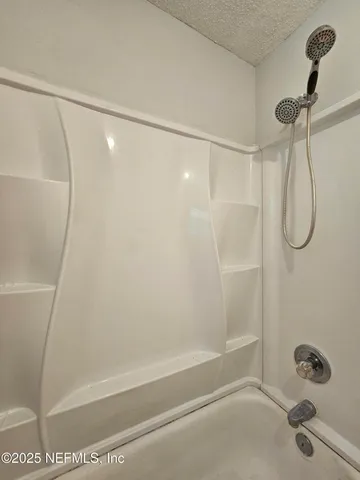 a bathroom with a shower and a shower