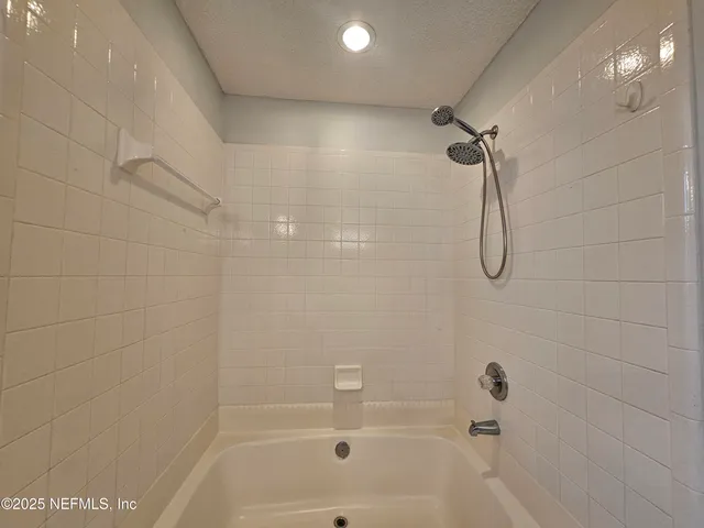 a bathroom with a shower and a bath tub