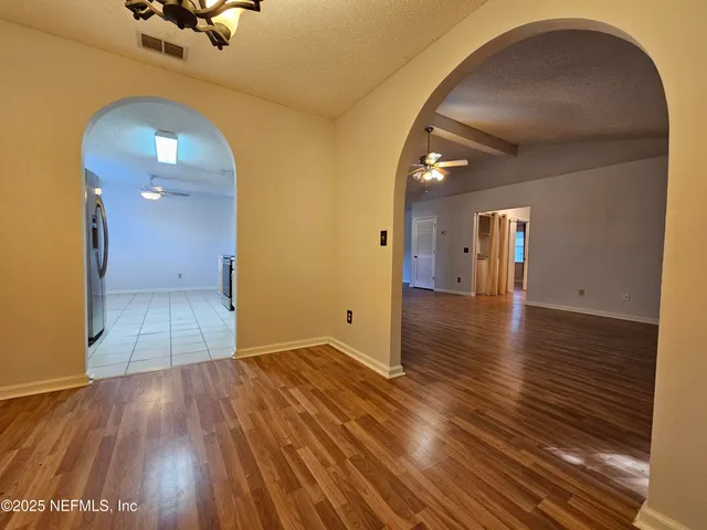 a view of a room with wooden floor
