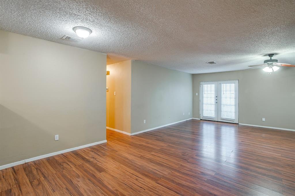1906 Beacon Way Fort Worth, TX 76140 - Photo 11 of 36 a view of an empty room with wooden floor and a window
