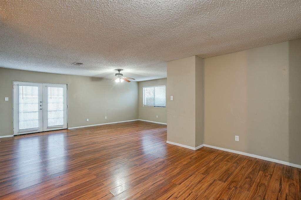 1906 Beacon Way Fort Worth, TX 76140 - Photo 12 of 36 a view of an empty room with wooden floor and a window
