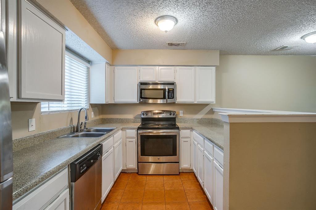 1906 Beacon Way Fort Worth, TX 76140 - Photo 13 of 36 a kitchen with a sink stove and microwave