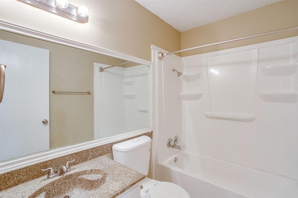 1906 Beacon Way Fort Worth, TX 76140 - Photo 20 of 36 a bathroom with a granite countertop bathtub shower sink vanity and toilet