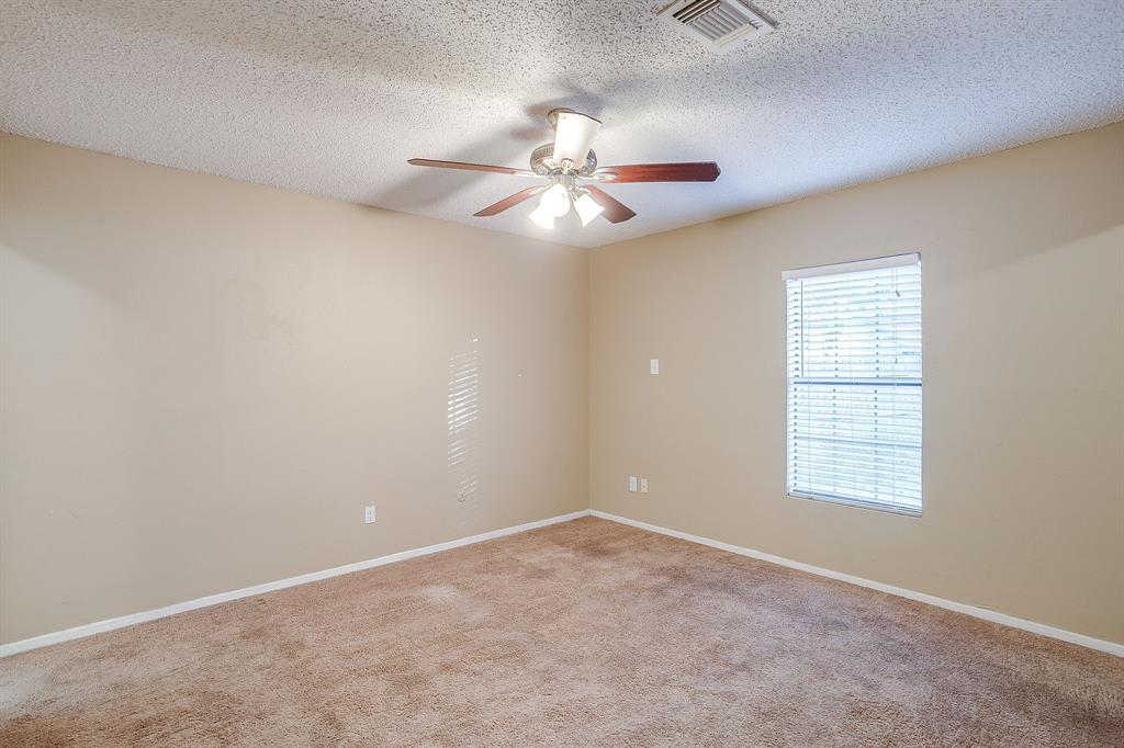 1906 Beacon Way Fort Worth, TX 76140 - Photo 21 of 36 en empty room with windows and fan