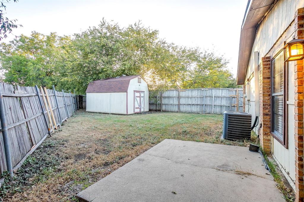 1906 Beacon Way Fort Worth, TX 76140 - Photo 29 of 36 a backyard of a house with a garden and deck