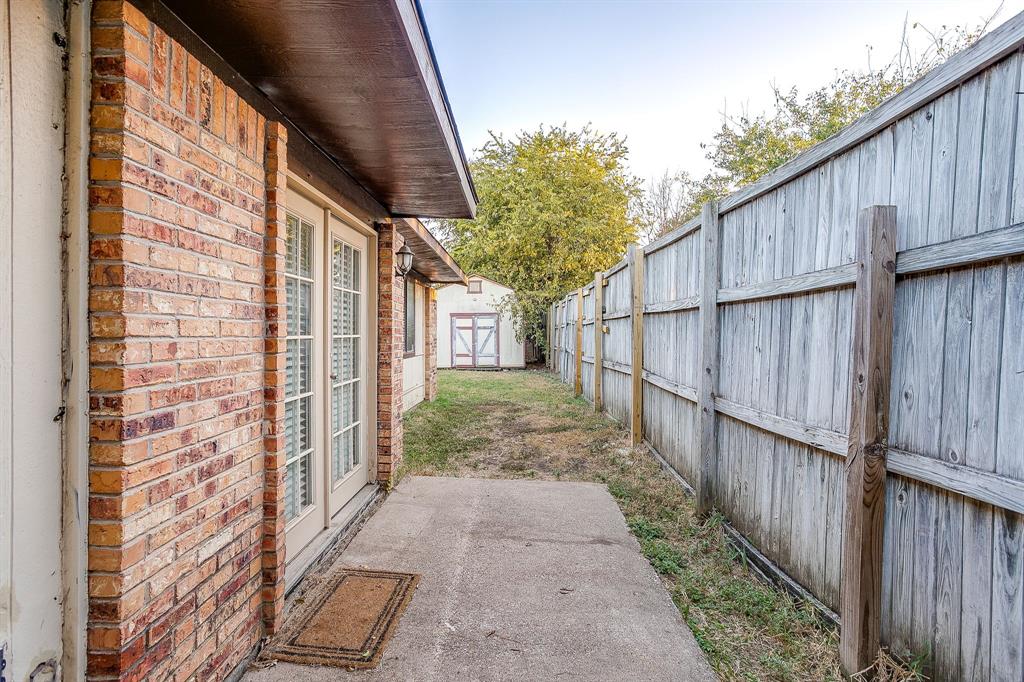 1906 Beacon Way Fort Worth, TX 76140 - Photo 33 of 36 a view of a pathway with wooden house and wooden fence