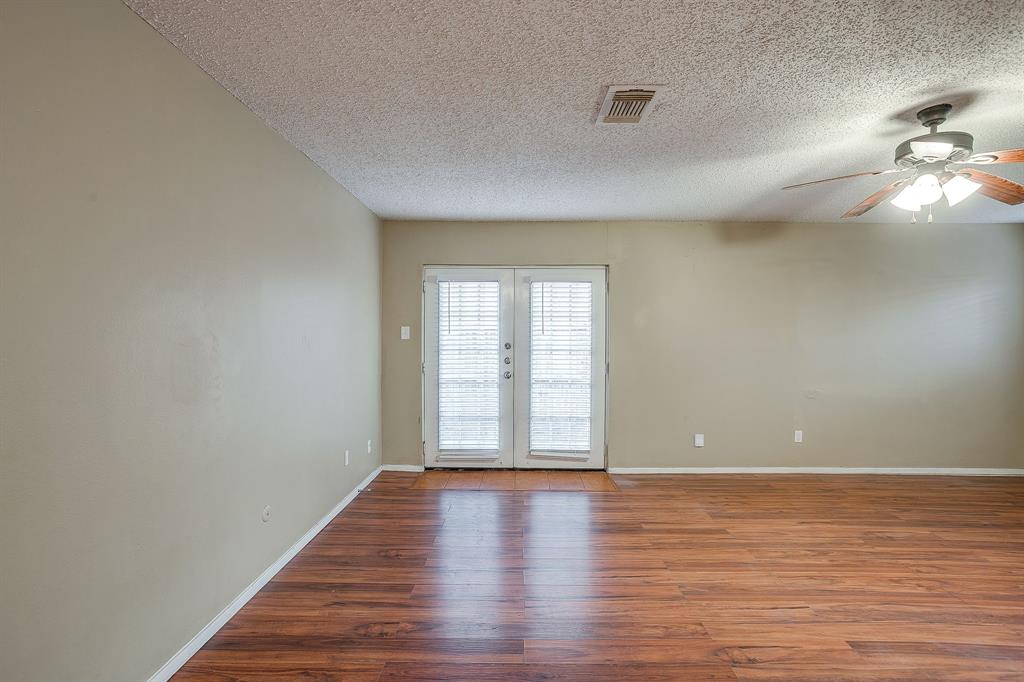 1906 Beacon Way Fort Worth, TX 76140 - Photo 5 of 36 wooden floor in an empty room with a window