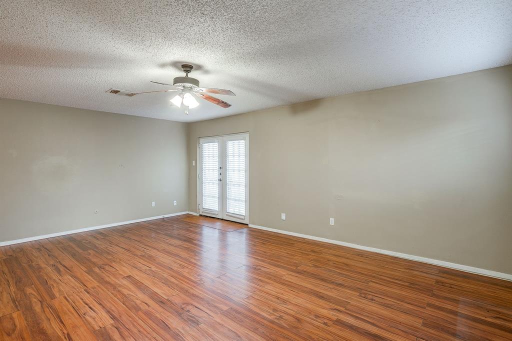 1906 Beacon Way Fort Worth, TX 76140 - Photo 6 of 36 a view of an empty room with window and wooden floor