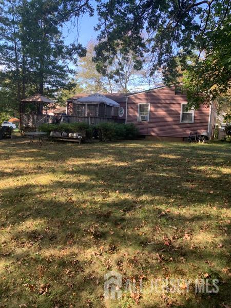 131 Morningside Road Colonia, NJ 07067 - Photo 3 of 3 a front view of a building with a garden
