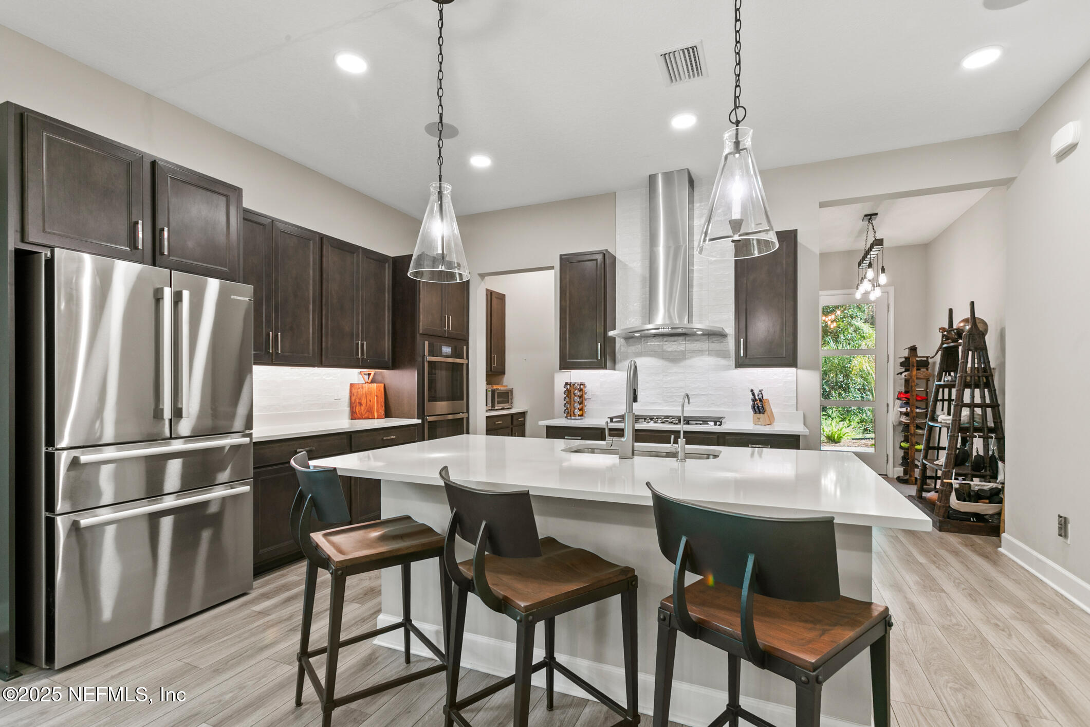 11080 Engineering Way Jacksonville, FL 32256 - Photo 14 of 74 a kitchen with refrigerator a sink and chairs