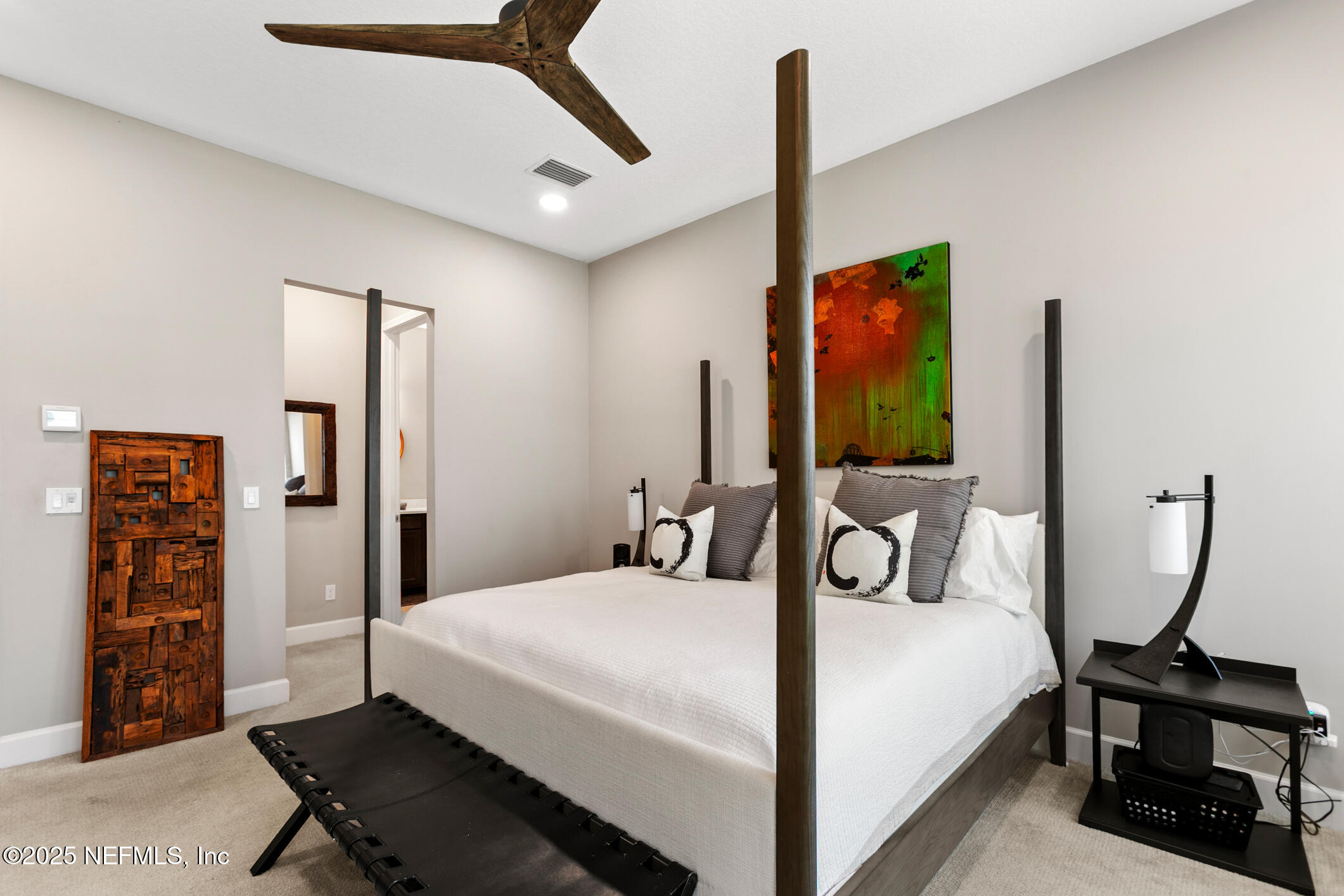 11080 Engineering Way Jacksonville, FL 32256 - Photo 24 of 74 a bedroom with a bed a dresser and potted plants