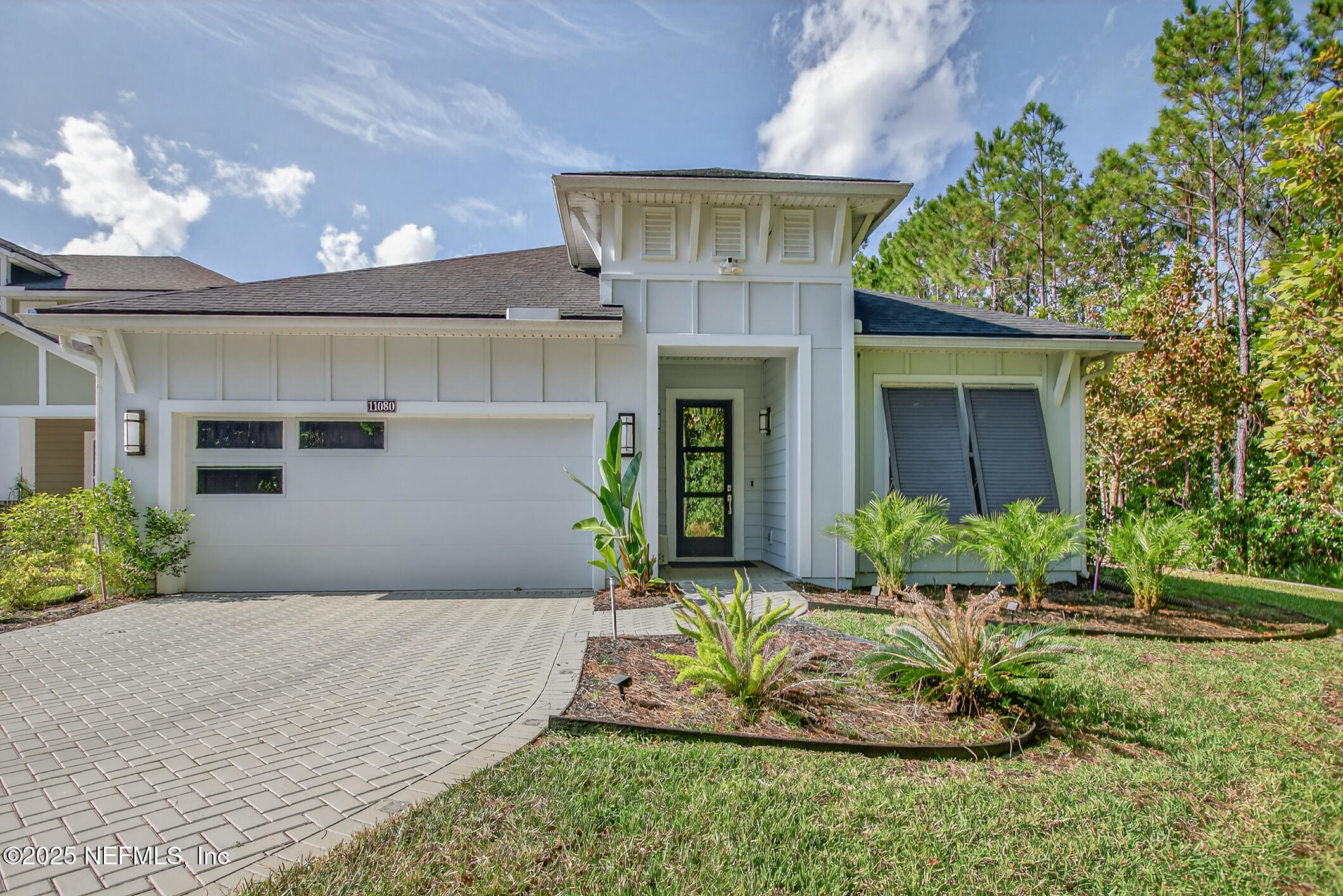 11080 Engineering Way Jacksonville, FL 32256 - Photo 3 of 74 a front view of a house with a yard and potted plants