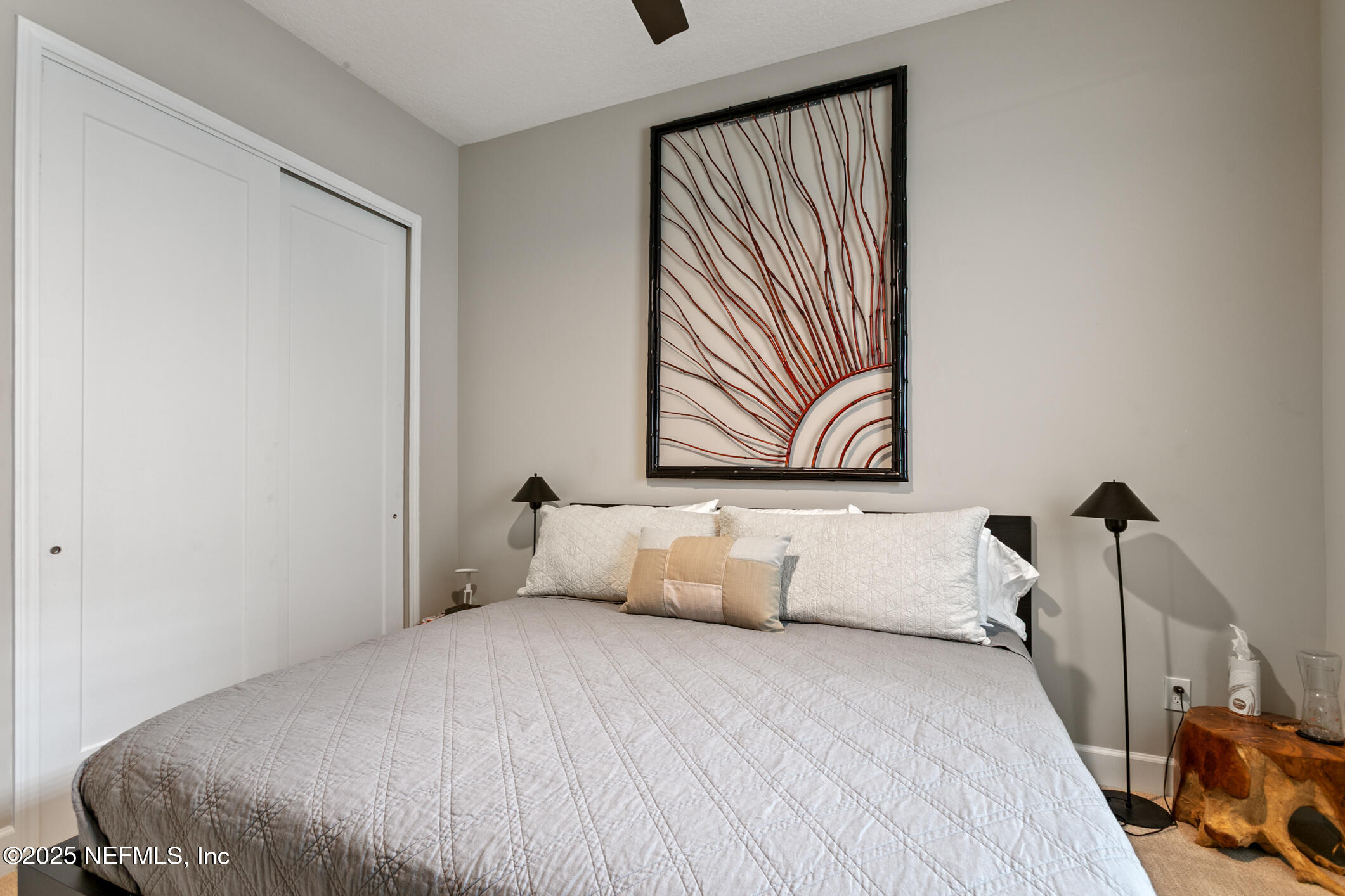 11080 Engineering Way Jacksonville, FL 32256 - Photo 35 of 74 a bedroom with a bed and a painting on the wall