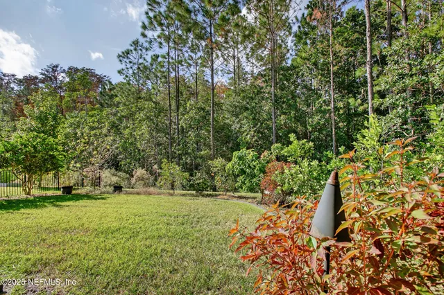 a view of a swimming pool with a patio and a yard