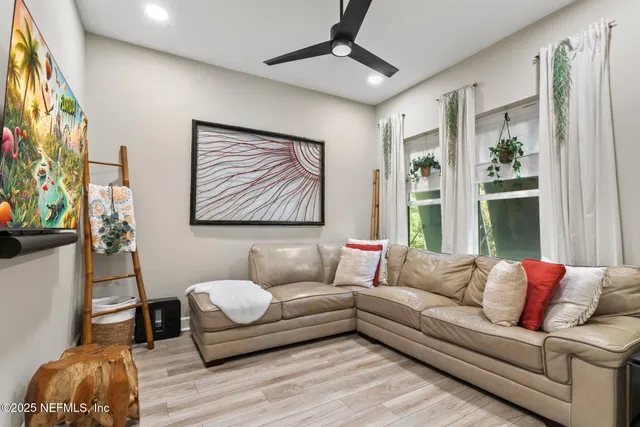 a bedroom with furniture and a ceiling fan