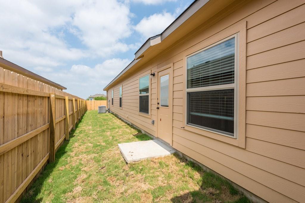 491 Jack Rabbit Lane, Unit A Buda, TX 78610 - Photo 21 of 22 Fenced backyard with ample green space offers a private outdoor retreat.