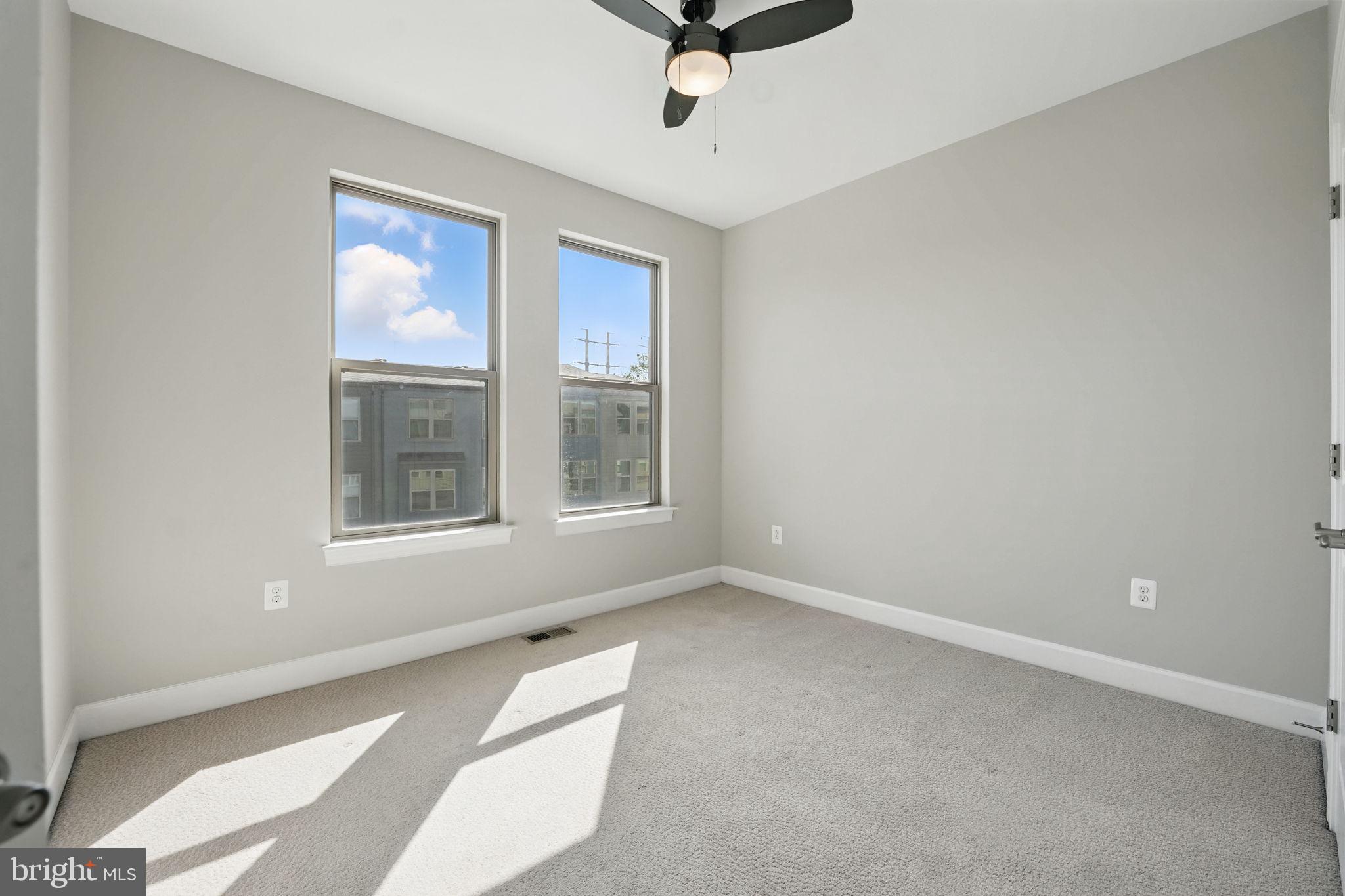 9870 Buchanan Loop Manassas, VA 20110 - Photo 20 of 41 an empty room with windows and ceiling fan