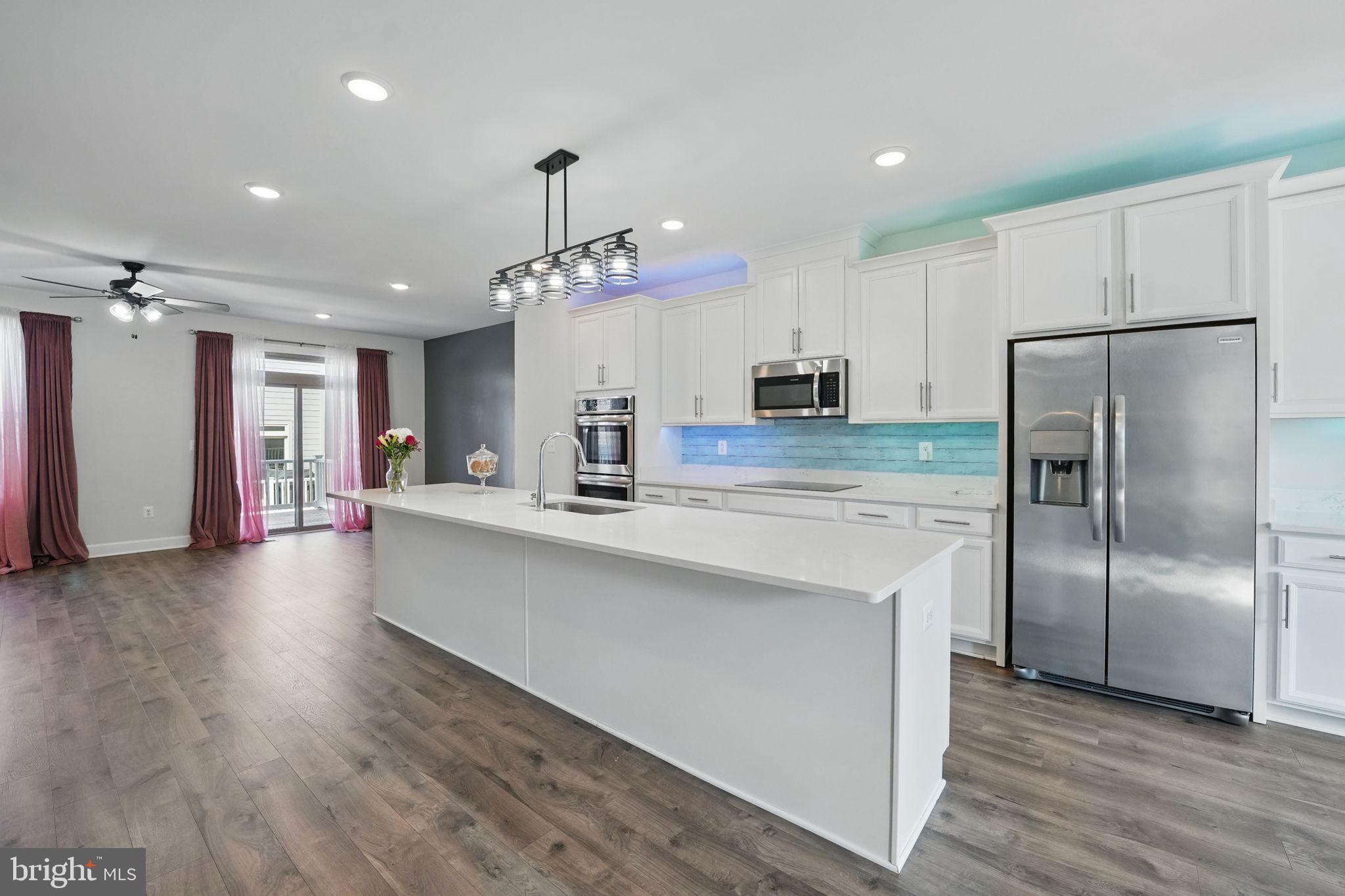 9870 Buchanan Loop Manassas, VA 20110 - Photo 6 of 41 a kitchen with stainless steel appliances a refrigerator sink and microwave