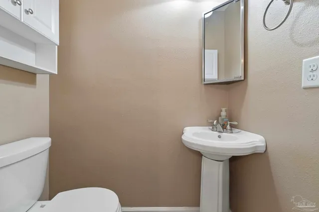 a bathroom with a sink a mirror and a toilet