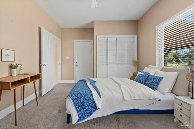 a bedroom with a bed and a table in it