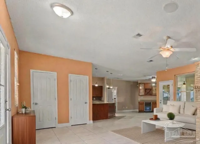 a living room with furniture a chandelier and a flat screen tv