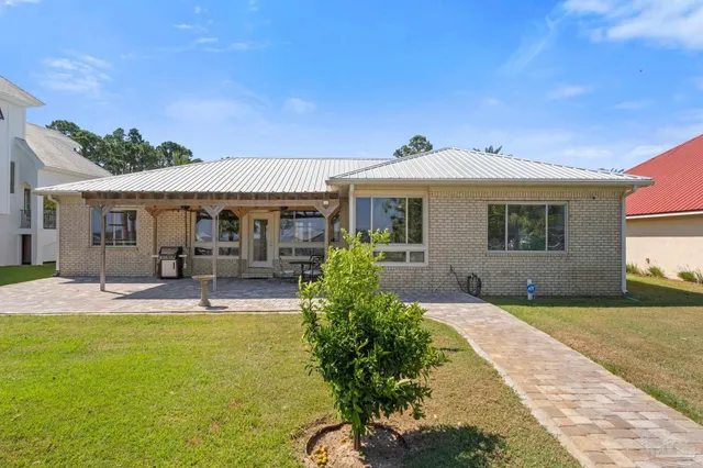 a front view of a house with a garden and patio
