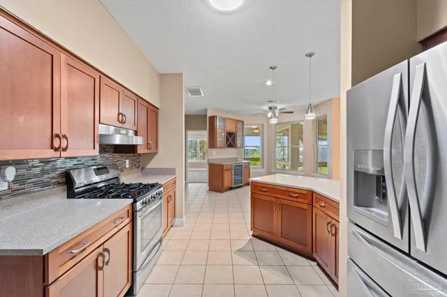 a kitchen with stainless steel appliances a refrigerator stove and sink