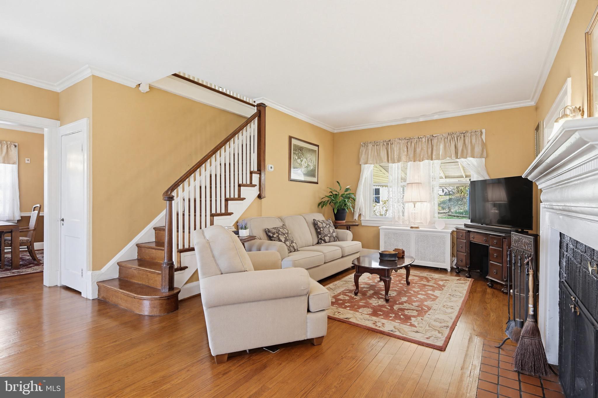 705 Winans Way Baltimore, MD 21229 - Photo 10 of 43 Bright living room with fireplace and wood floors