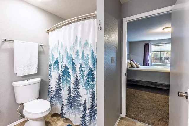 a bathroom with a toilet sink and a mirror