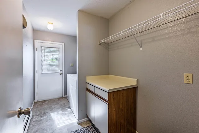 a utility room with cabinets washer and dryer