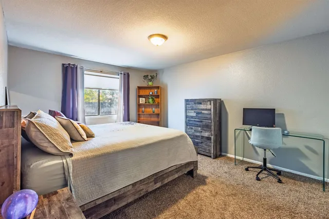 a bedroom with a bed and a desk