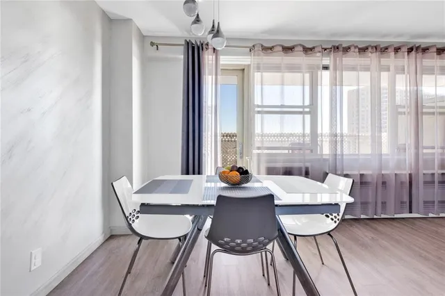 a view of a dining room with furniture window and wooden floor
