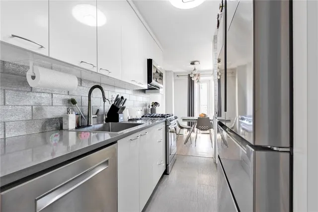 a kitchen with a sink appliances and cabinets