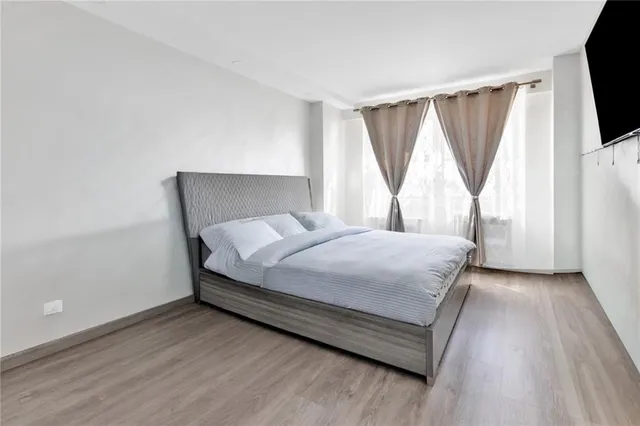 a bed sitting in a room next to a window