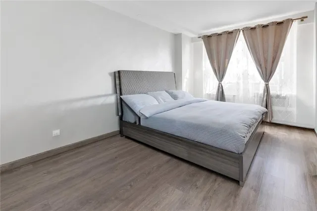 a bed sitting in a bedroom next to a window