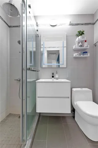 a bathroom with a sink toilet and shower