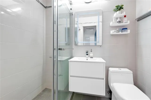 a bathroom with a sink mirror and toilet