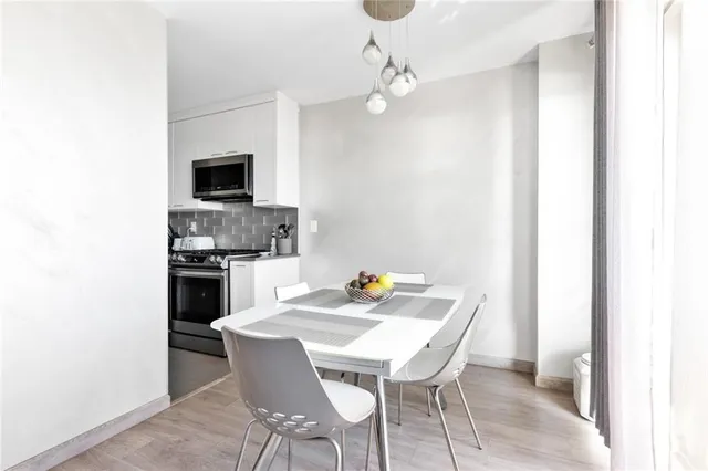 a view of a dining room with furniture and a kitchen