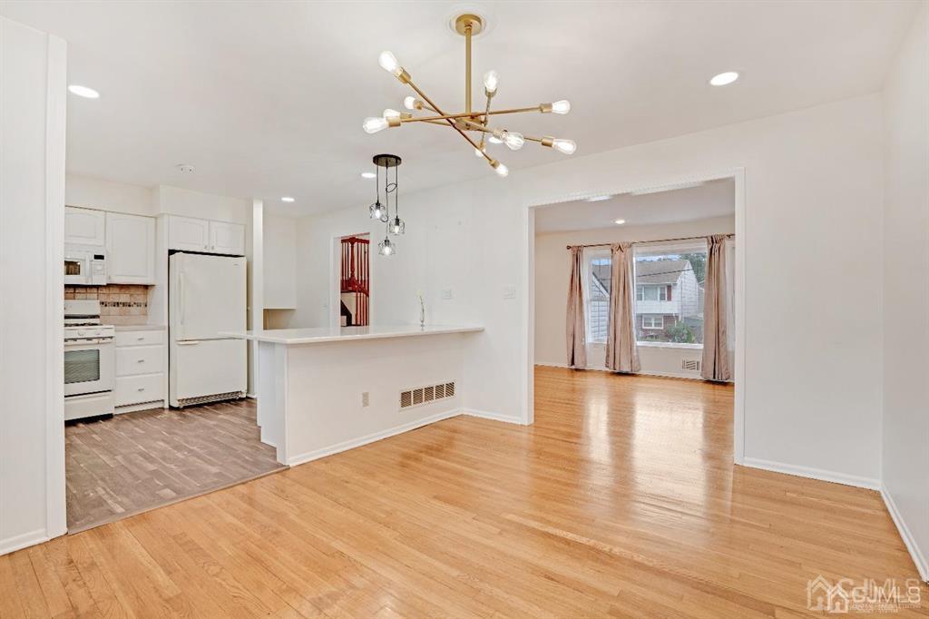 63 South Cliff Road Colonia, NJ 07067 - Photo 1 of 37 a view of a kitchen with wooden floor and a sink