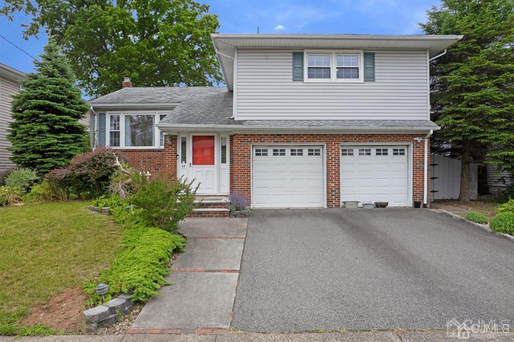 63 South Cliff Road Colonia, NJ 07067 - Photo 2 of 37 a view of a house with a yard and a garage