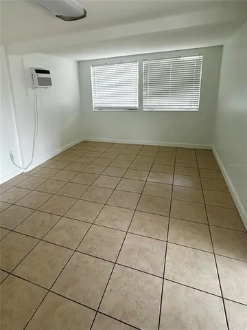 a view of an empty room and a window