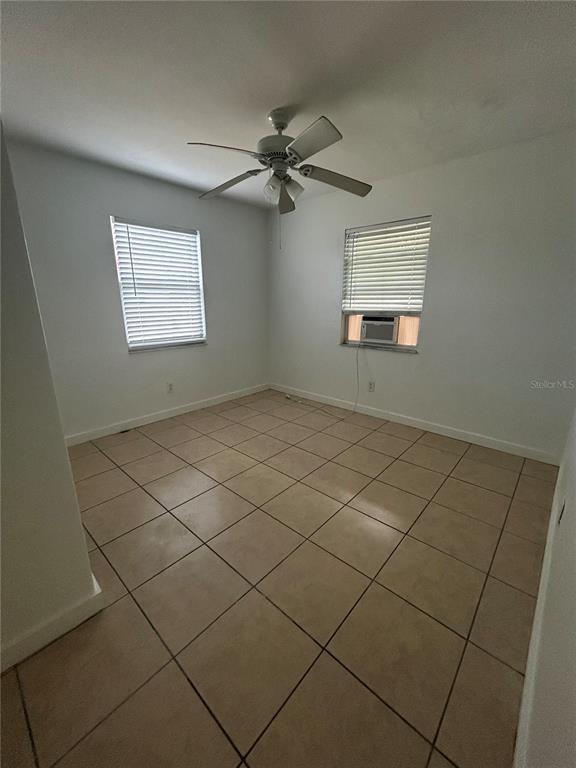 2695 Fruitville Road Sarasota, FL 34237 - Photo 9 of 13 an empty room with windows and fan