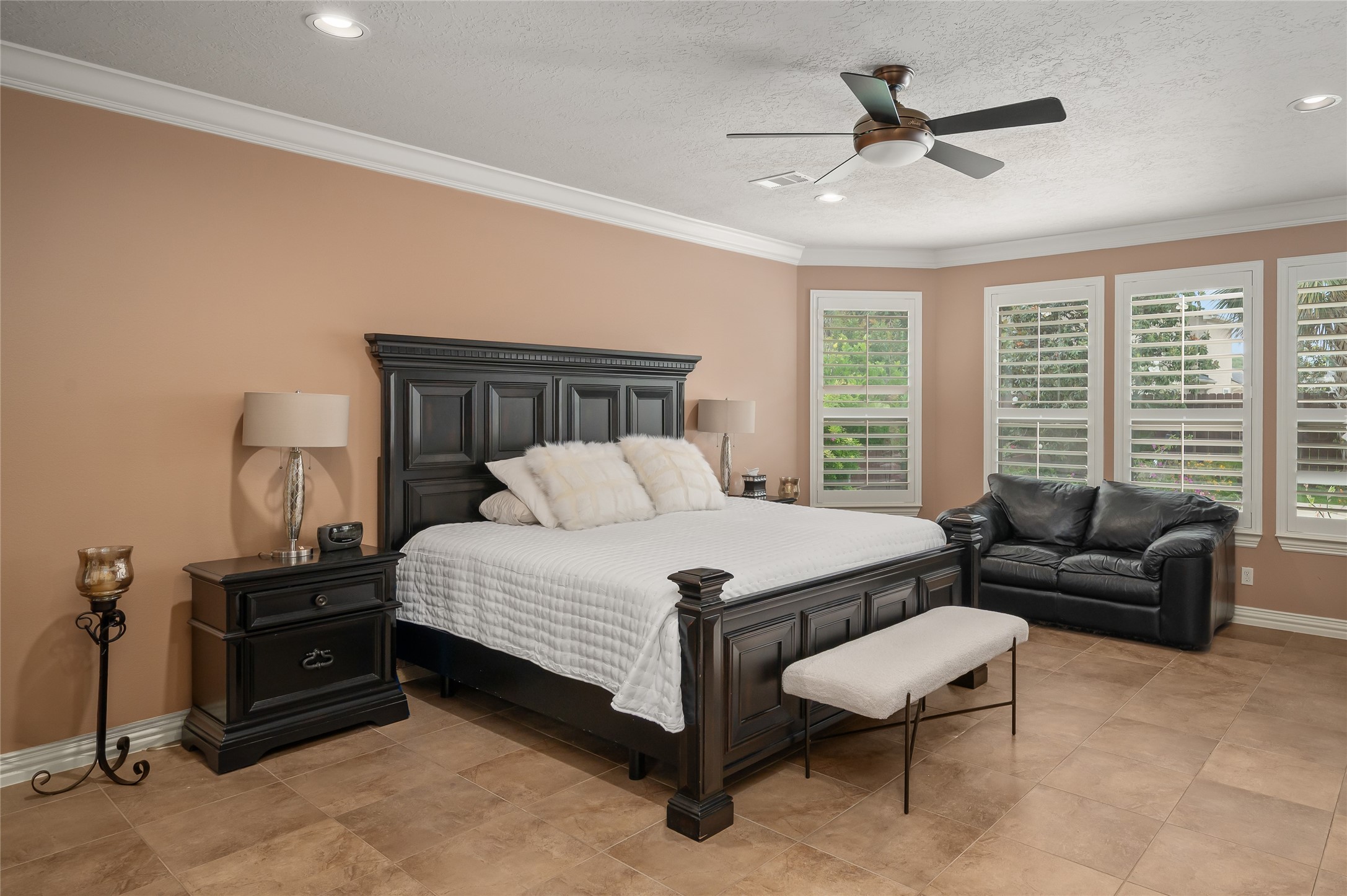 2127 Thicket Ridge Lane Houston, TX 77077 - Photo 20 of 48 The oversized primary bedroom showcases plantation shutters with a view of the resort like backyard and a door that leads directly to the patio and pool.