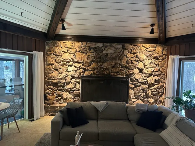 a living room with a couch and a fireplace